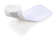 Single Cosmopor E sterile adhesive dressing with non-stick pad shown on white background.
