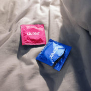 Durex Surprise Me Variety Pack Condoms 40 Count Lifestyle Image Condoms on Fabric Surface