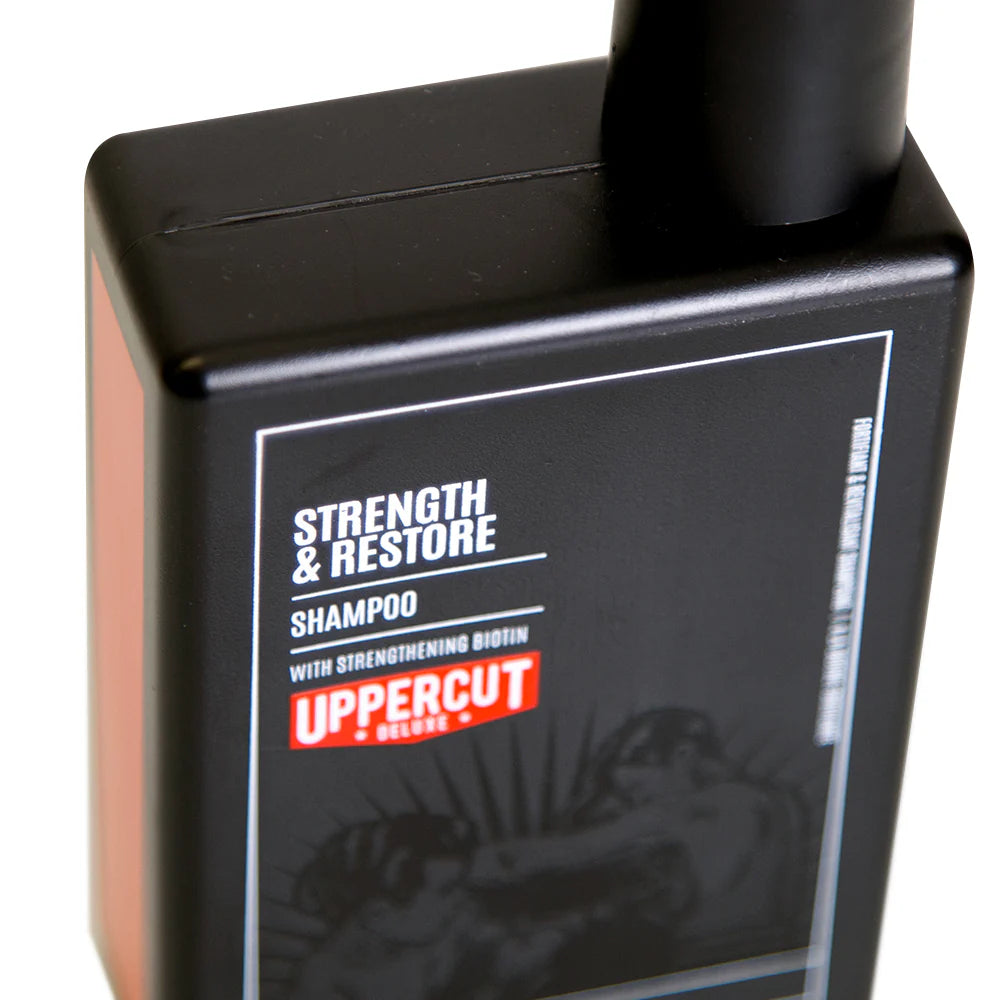 Side image: Uppercut Deluxe Strength and Restore Shampoo 240ml bottle mandarin patchouli fragrance packaging