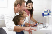 Lifestyle/use image: Pristine Gleam medium toothbrush daily oral care plastic handle nylon bristles 4 pack